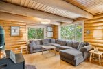 Log beams create a warm space in the main level seating area.